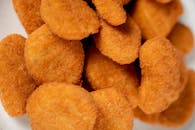 Golden crispy chicken nuggets perfectly breaded for a tasty treat.