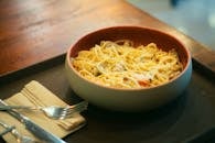 Delicious spaghetti carbonara with cheese served in a cozy setting. Perfect for meal inspiration.