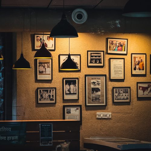 Warm cafe corner in Pune with vintage photo frames and cozy lighting creating an inviting ambiance.